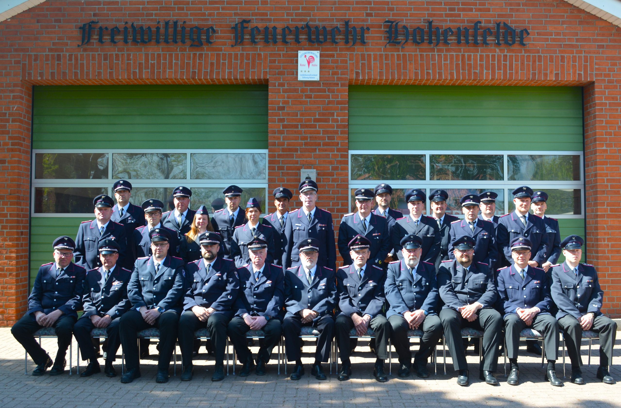 Ein grün blaues Wappen mit Schriftzug SG Hohenfelde